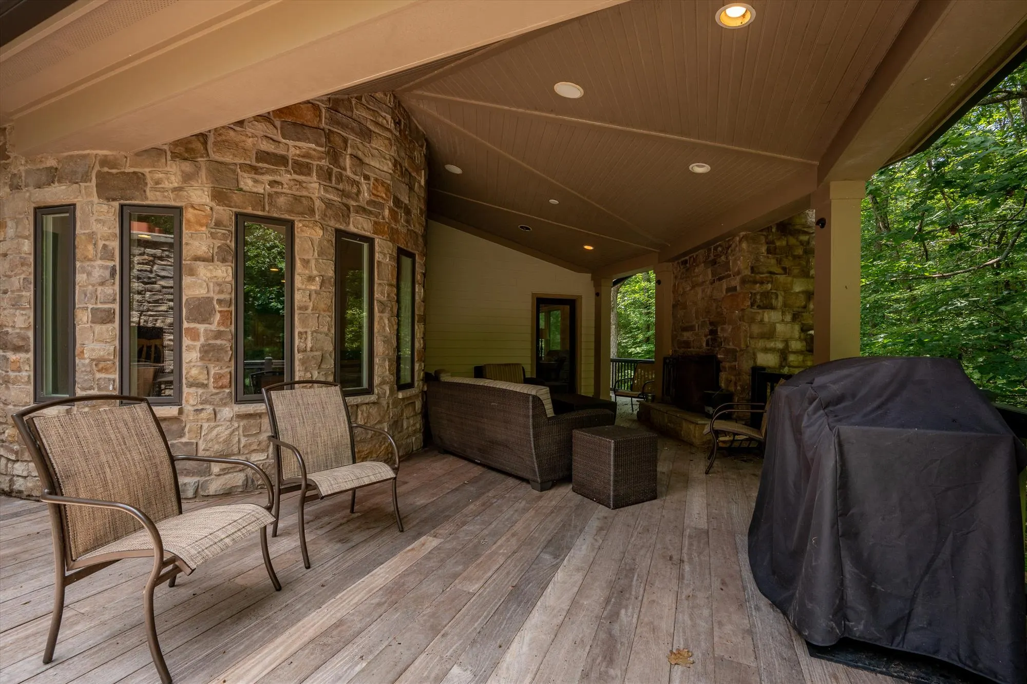 Multi-level deck connecting outdoor living spaces with gas grill area
