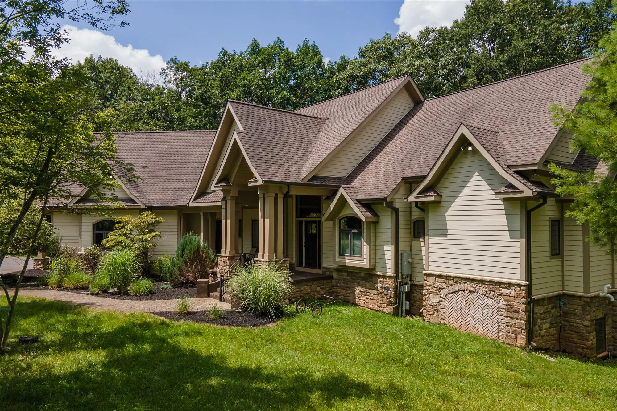 Woodland Chalet's gabled mountain exterior with stone accents, framed by the surrounding forest