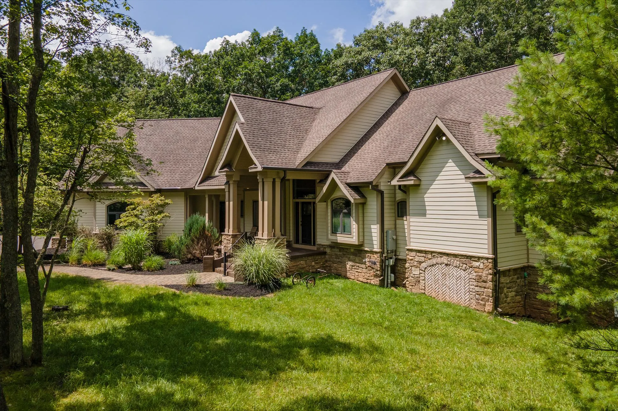 Woodland Chalet exterior with driveway approach through mature forest