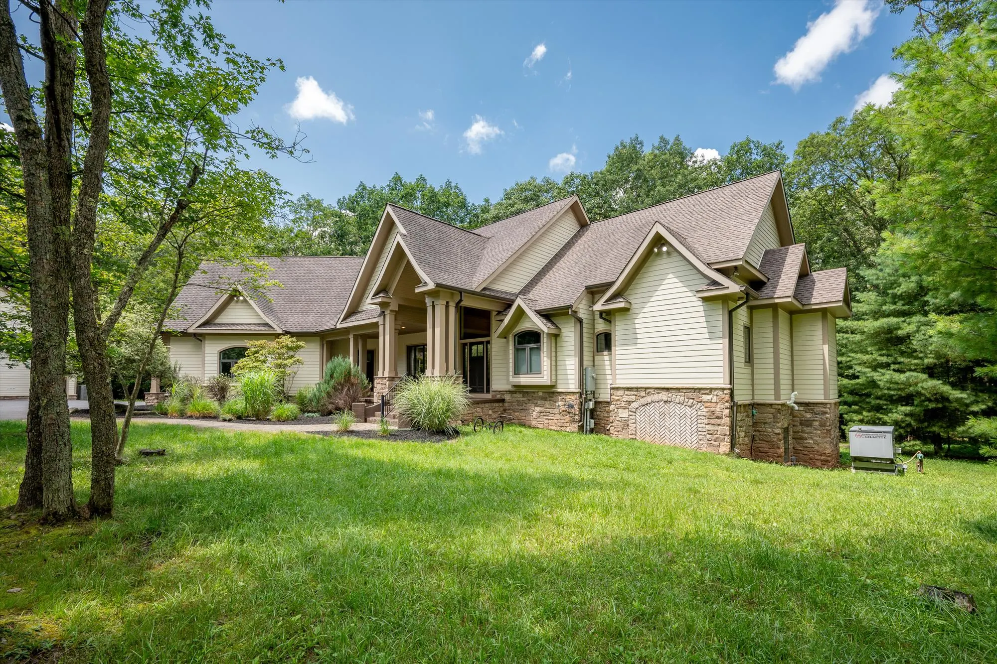 Woodland Chalet front exterior nestled among tall trees at Deep Creek Lake