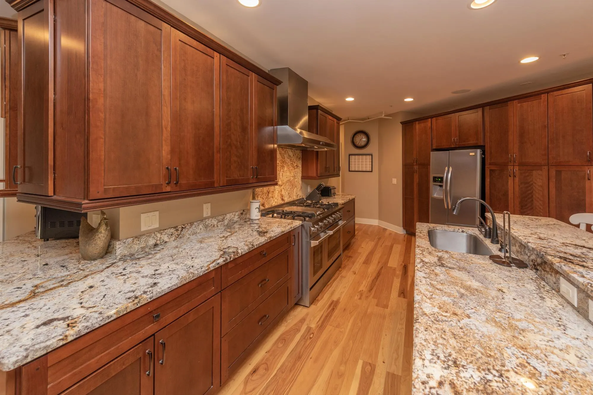 Main kitchen countertops and cabinetry with wine cooler and coffee station