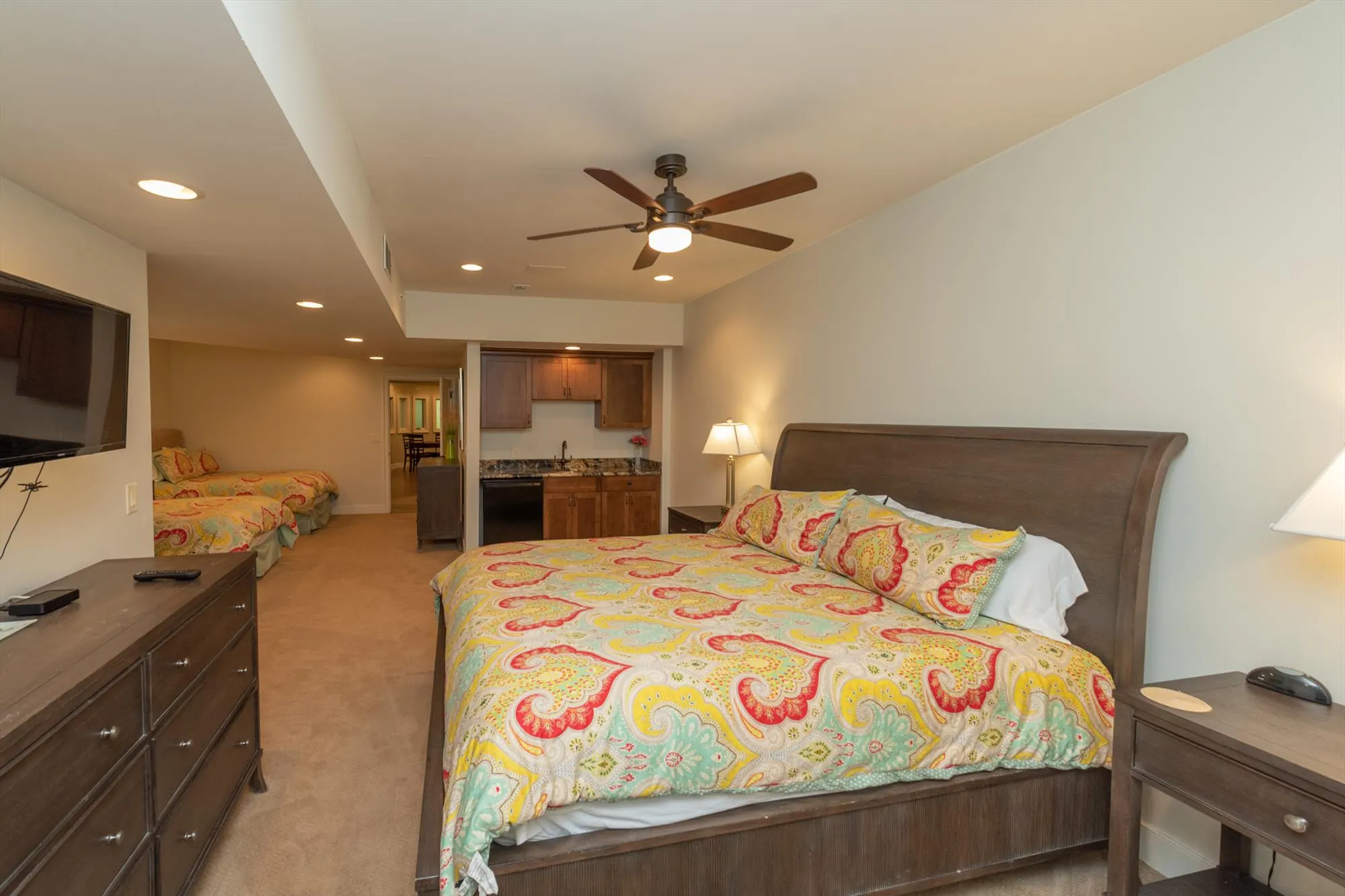 Lower level primary suite with king bed and two full beds for flexible sleeping