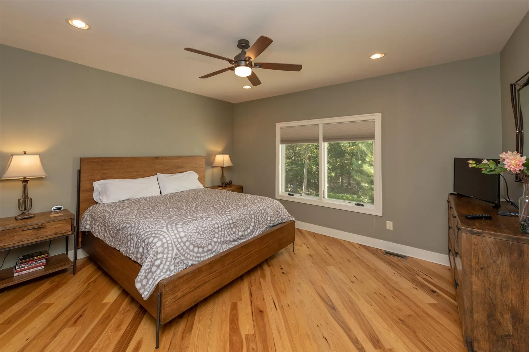 Second main level bedroom with comfortable king bed and warm lighting