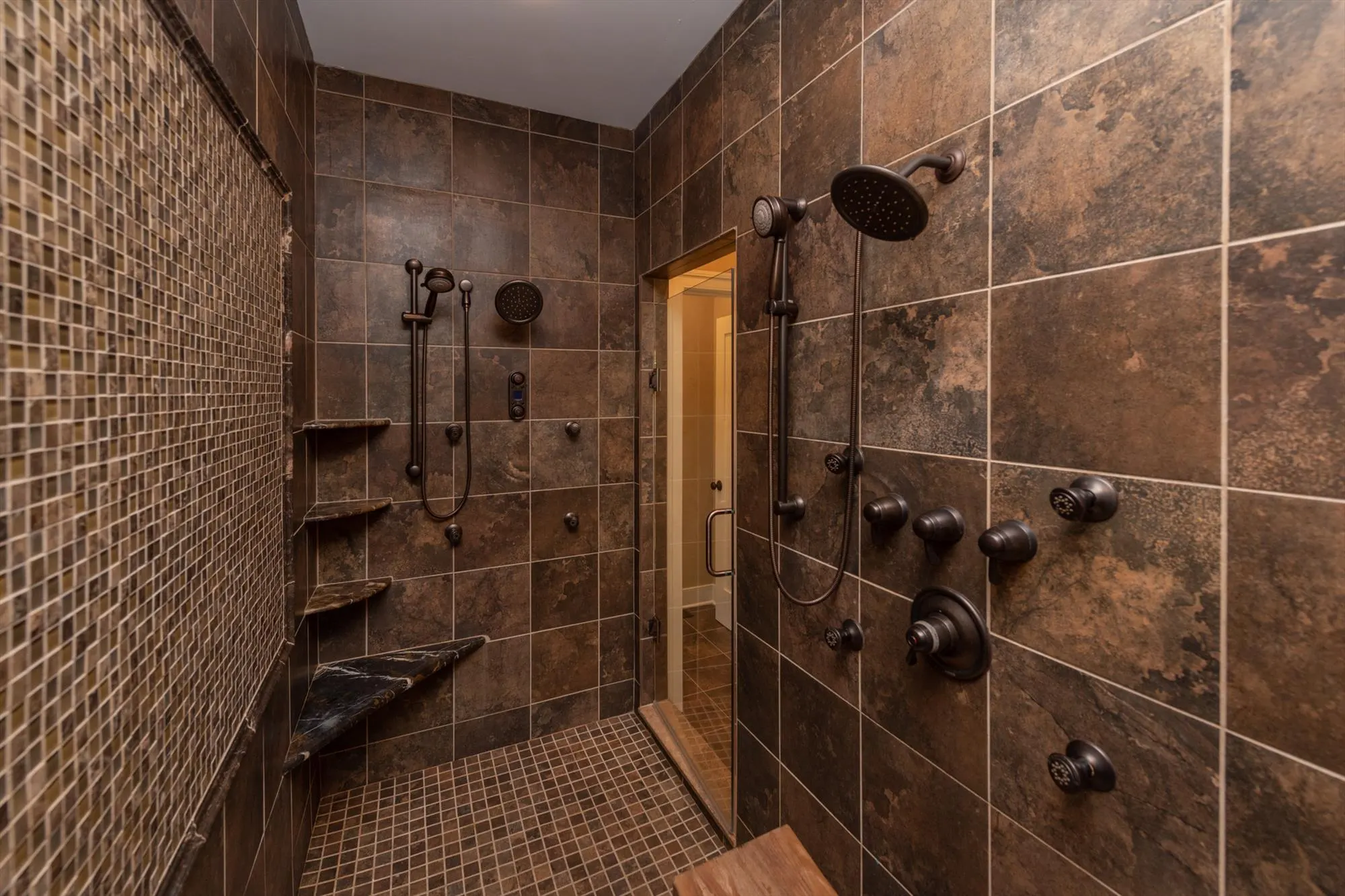 Walk-in shower with tile surround in the primary suite bathroom