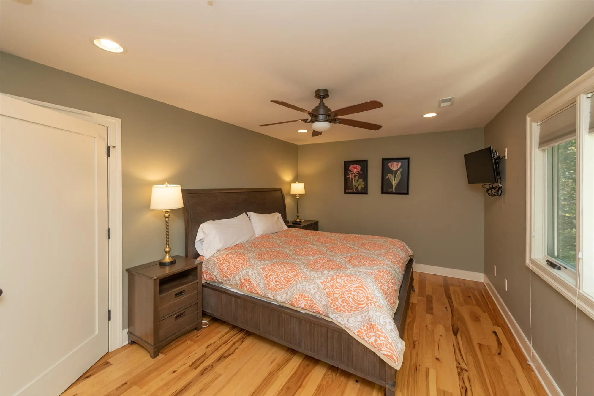 Second upper level bedroom with comfortable king bed and forest views